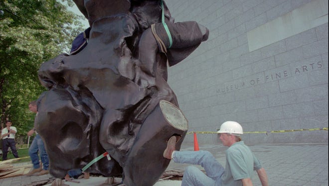 Art installation specialist Peter Watson, of New York City, right, helps install a William de Kooning bronze sculpture called "Standing Figure", (modeled in clay, 1969; cast in bronze, 1984), outside the West Wing entrance of the Museum of Fine Arts in Boston, Wednesday, Aug. 7, 1996. The abstract expressionist work of art weighs 7,500 lbs. and measures over 12 feet high and 21 feet wide. (AP Photo/Bizuayehu Tesfaye)