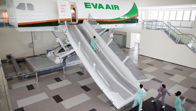 Trainees practice emergency evacutions from a full-size, full-motion Boeing 777 cabin simulator at EVA Air's training center near Taipei, Taiwan.