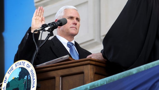 Indiana Supreme Court Chief Justice Brent E. Dickson, right, administers the oath of office to Gov. Mike Pence during the inauguration ceremony on the west steps of the Statehouse on Monday, January 14, 2013. Charlie Nye / The Star.