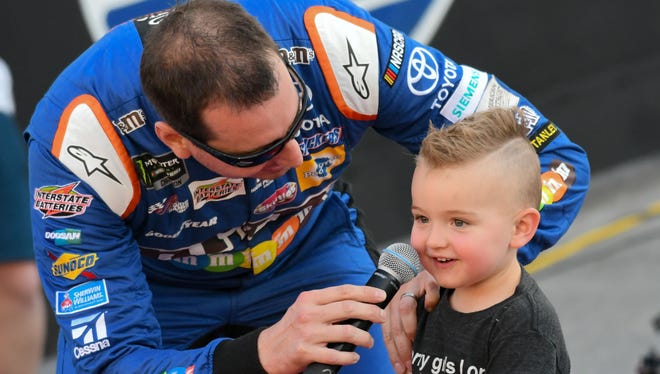 Aug. 19: Kyle Busch, shown here with son Brexton during driver introductions, wins the Bass Pro Shops NRA Night Race at Bristol Motor Speedway.