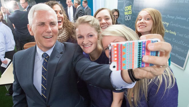 Gov. Mike Pence takes a selfie with supporters.