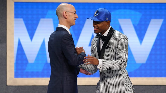 Dennis Smith, Jr. (NC State) is introduced by NBA commissioner Adam Silver as the number nine overall pick.