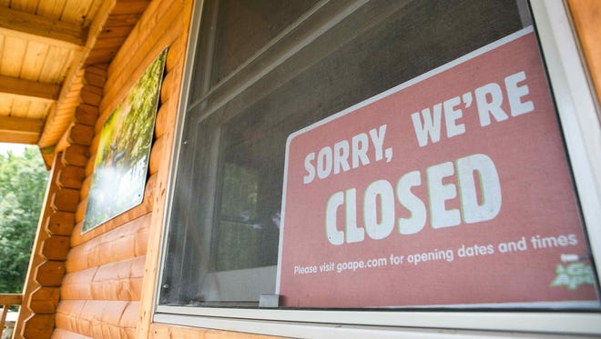 A closed sign on the window of Go Ape at Lums Pond which remains closed after the death of a Felton woman when she fell to her death last week.