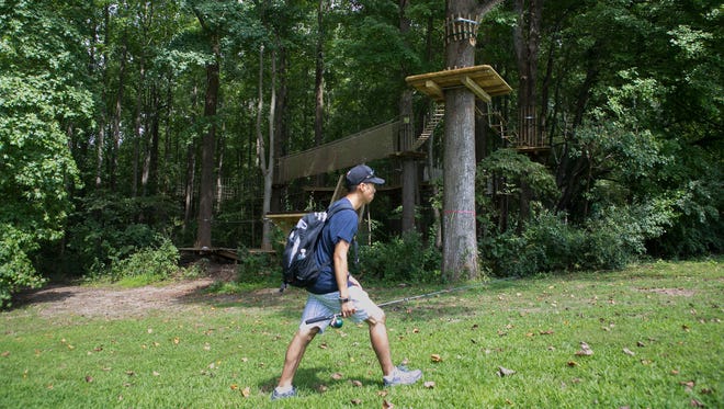 A park attendee walks by the closed Go Ape Zip Line & Treetop Adventure which remains closed after the death of a Felton woman when she fell to her death Wednesday afternoon.