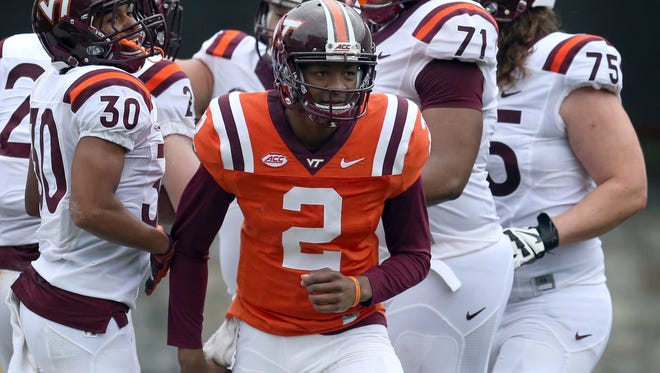 Virginia Tech quarterback Hendon Hooker celebrates with his offensive teammates after throwing a touchdown pass during the team's spring game.