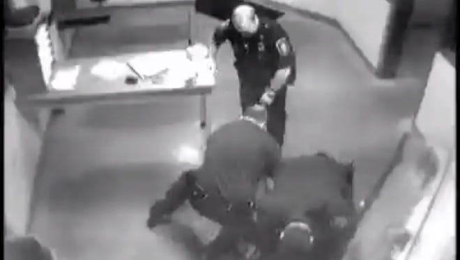 In this screen grab from a Genesse County (Mich.) jail video, law-enforcement officers are shown beating William Jennings of Flint Township, Mich., after a drunk-driving arrest on Sept. 18, 2010.