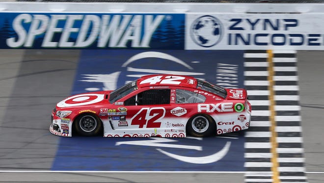 Kyle Larson crosses the finish line to win the Pure Michigan 400 at Michigan  International Speedway.