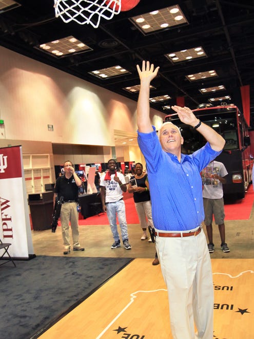 Republican candidate for Indiana governor Congressman Mike Pence takes a shot at the basket as he shoots from a basketball floor marked with the IU satellite campuses around the state at Indiana Black Expo, Inc.'s Summer Celebration in the Indiana Convention Center on Saturday, July 21, 2012. Charlie Nye / The Star.