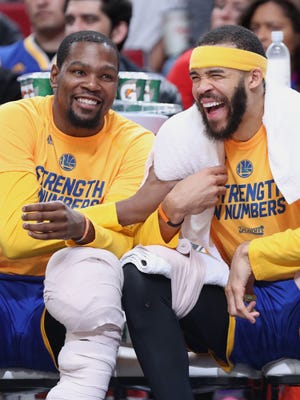 Golden State Warriors forward Kevin Durant, center JaVale McGee and guard Stephen Curry react in the closing the seconds of a 128-103 win over the Portland Trail Blazers to clinch Game 4 of the first round of the 2017 NBA Playoffs.