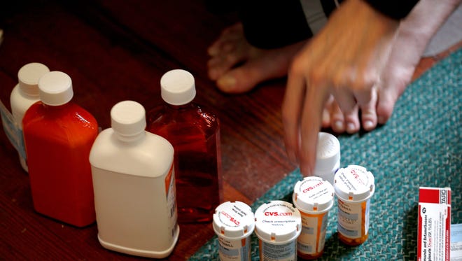 Medicaid patient Richard Cotterill, 28, of Springdale, Ohio shows the medications he takes He has also been on liquid nutrition, which he takes in through a tube in his stomach, for two years.