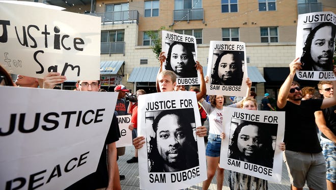 Demonstrators chant "No justice, no peace" during a Countdown to Conviction Coalition rally for justice for Sam DuBose on Freedom Way at The Banks Saturday, July 22, 2017. Sam DuBose was unarmed when he was shot and killed during a traffic stop by former University of Cincinnati police officer Ray Tensing, July 19, 2015.