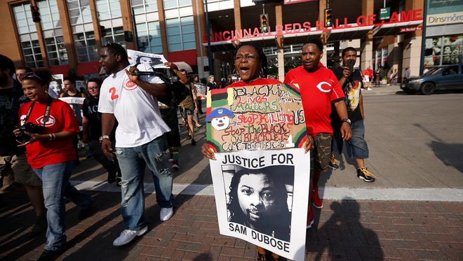 Kendra Sheppard of Downtown and others march along Freedom Way during a Countdown to Conviction Coalition rally for justice for Sam DuBose Saturday, July 22, 2017. Sam DuBose was unarmed when he was shot and killed during a traffic stop by former University of Cincinnati police officer Ray Tensing, July 19, 2015. Tensing was tried two times, both trials ended in hung juries.