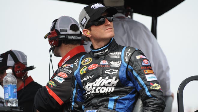 Kasey Kahne watches the Sprint Cup race at Martinsville Speedway from teammate Jeff Gordon's pit box blowing an engine early in the April 2012 race. Kahne replaced Mark Martin at Hendrick Motorsports at the beginning of 2012.