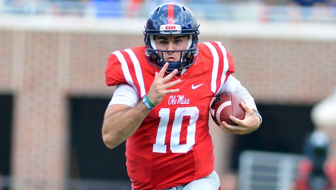 Mississippi Rebels quarterback Chad Kelly (10) runs the ball during a play that would result in a touchdown during the third quarter of the game against the Georgia Bulldogs at Vaught-Hemingway Stadium.