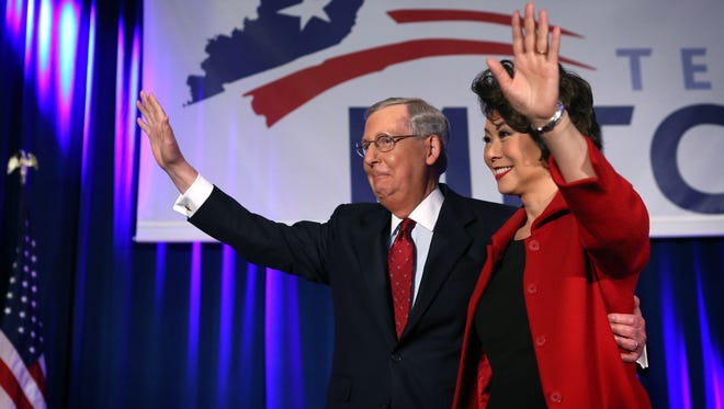 Sen. Mitch McConnell and Elaine Chao wave to supporters at a victory celebration in Kentucky after McConnell won re-election Nov. 4, 2014.