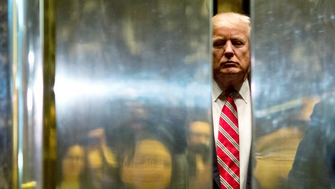 President-elect Donald Trump boards the elevator at Trump Tower on Jan. 16, 2017, in New York.