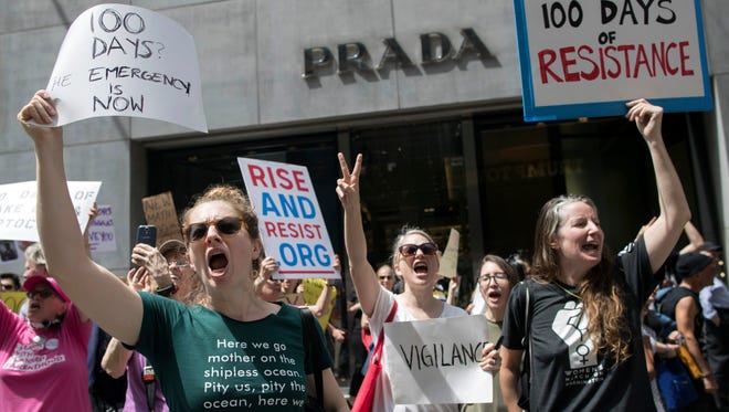 Demonstrators chant "shame" as they march past Trump Tower during "100 Days of Failure" protest and march, Saturday, April 29, 2017, in New York. Thousands of people across the U.S. are marking President Donald Trump's hundredth day in office by marching in protest of his environmental policies.