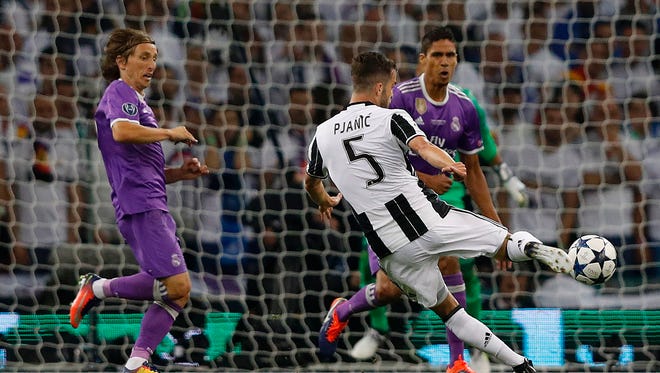 Juventus midfielder Miralem Pjanic takes a shot on goal in the first half.