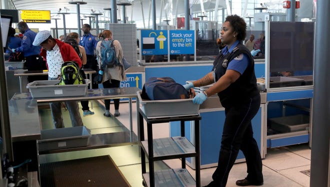 A Transportation Security Administration officer handles a bag for secondary screening at a new checkpoint with automated screening lanes at Terminal 4 at John F. Kennedy International Airport  in Queens, New York, on May 17, 2017.