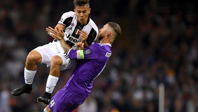 Paulo Dybala of Juventus  and Sergio Ramos of Real Madrid battle for possession in the first half.