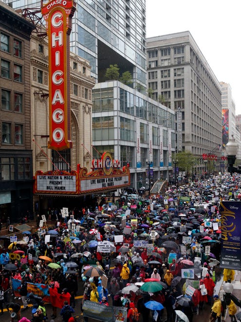 Demonstrators march on State Street during "100 Days of Failure" protest and march in Chicago. Thousands of people across the U.S. are marking President Donald Trump's hundredth day in office by marching in protest of his environmental policies.