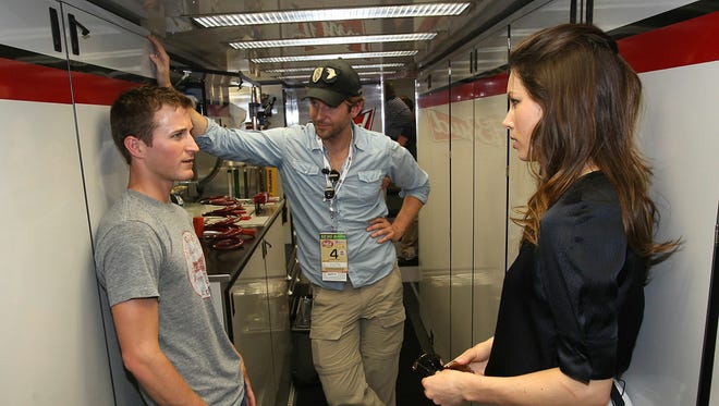 Kasey Kahne, left, hangs out with actors Bradley Cooper, center, and Jessica Biel in his team hauler prior to the 2010 Coca-Cola 600 at Charlotte Motor Speedway.