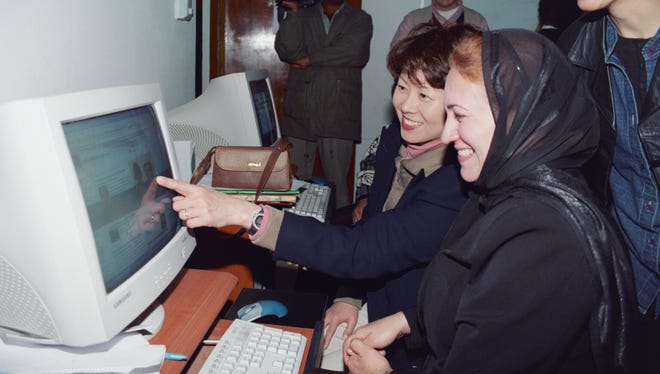 Chao visits with Iraqi women at a Women and Democracy Center in Hilla, Iraq, where many were learning computer skills.