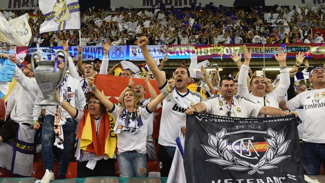 Real Madrid fans cheer before the game.