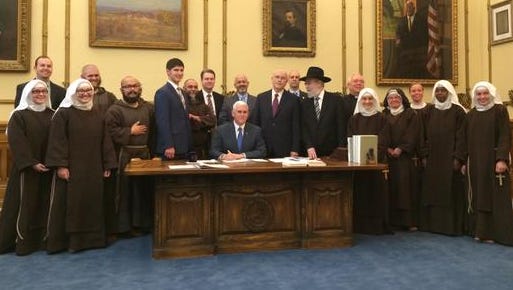 The governor's office tweeted this photo of Gov. Mike Pence signing Indiana's "religious freedom" bill.