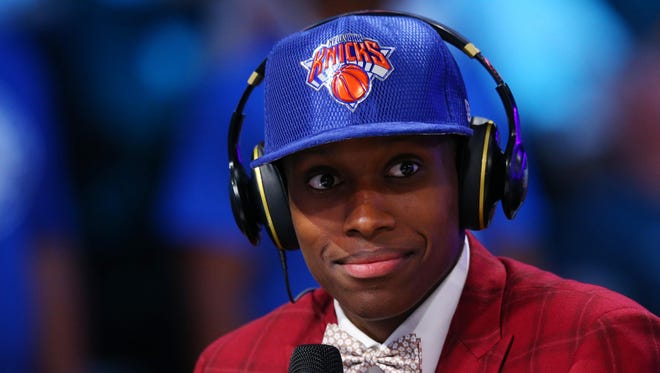 Frank Ntilikina shows off a slick suit and a new Knicks hat after being drafted No. 8 overall in the 2017 NBA draft at Barclays Center.