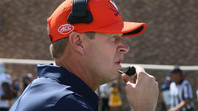 The contract of Virginia's Bronco Mendenhall requires him to seek employment if he is no longer employed as the Cavaliers' head coach.