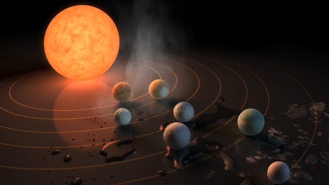 Artist concept of the TRAPPIST-1 star, an ultra-cool dwarf, has seven Earth-size planets orbiting it.