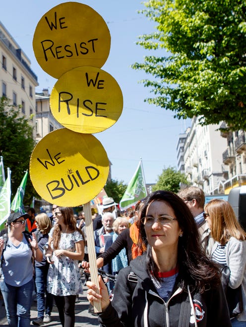 A person holds a sign for the World Climate March in Geneva, Switzerland on April 29, 2017.