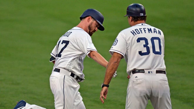 Aug. 30: Padres starting pitcher Travis Wood is congratulated by third base coach Glenn Hoffman after hitting a solo home run against the  Giants.