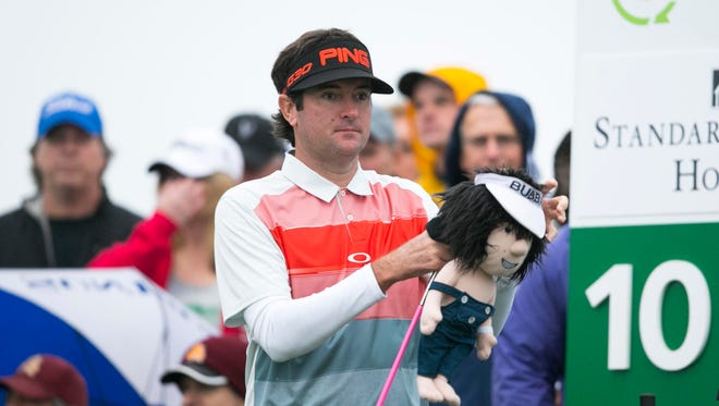 PGA golfer Bubba Watson takes his signature driver cover off of his signature pink driver.