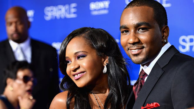 Bobbi Kristina Brown, left, and Nick Gordon arrive at Tri-Star Pictures' "Sparkle" premiere at Grauman's Chinese Theatre on Aug. 16, 2012 in Hollywood. New court documents released Friday, Oct. 9, 2015, say Gordon injected Brown with a toxic cocktail after putting her in a bathtub.