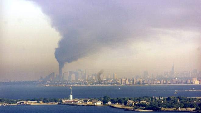 The World Trade Center sends up a plume of smoke as it burns on the Manhattan skyline Sept. 11, 2001.