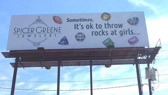 The Internet is ready to rumble with a local jewelry store for a controversial billboard that went up Monday with the phrase, 'Sometimes, it's OK to throw rocks at girls...'
Several posts attacking the Spicer Greene Jewelers' advertisement off Patton Avenue near Interstate 240 appeared on the popular Facebook group WAX, West Asheville Exchange.