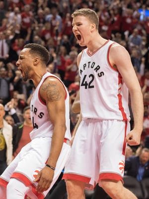Toronto Raptors guard Norman Powell and center Jakob Poeltl celebrate a basket during the fourth quarter in Game 5 of the first round of the 2017 NBA Playoffs.