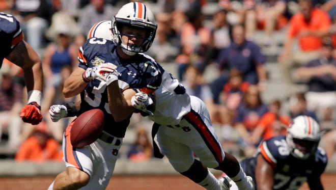 Auburn defender Michael Sherwood knocks the ball from receiver Will Hastings during the team's spring game.