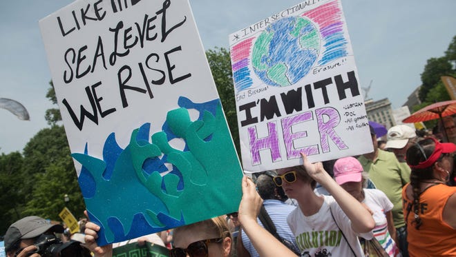 Protesters hold signs and chant in front of the White House during the People's Climate March in Washington.