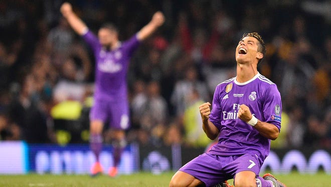 Real Madrid's Cristiano Ronaldo falls to his knees as he celebrates the vistory.