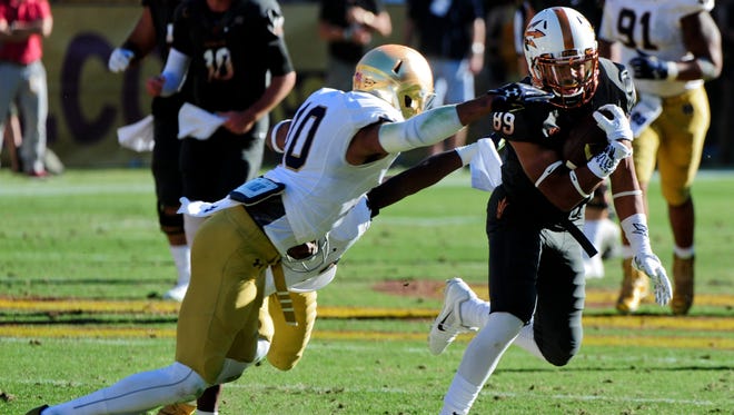 Notre Dame safety Max Redfield, left, attempts a tackle against Arizona State during the 2014 season.