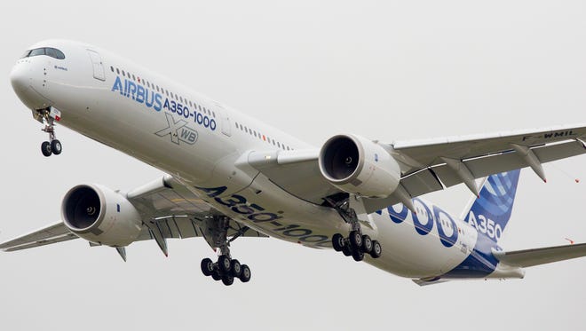 Airbus' new A350-1000 widebody jet returns to Toulouse-Blagnac International Airport in southern France on Nov. 24, 2016 after its maiden flight.