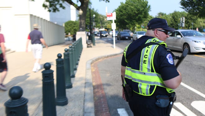 U.S. Capitol Police stand guard outside of  House of Representative Office Buildings after House Majority Whip Representative Steve Scalise and others were shot at by a gunman while playing baseball in Arlington , Va.