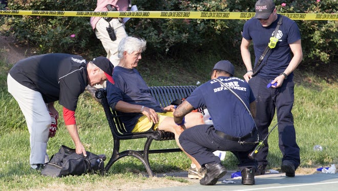 A man receives medical attention from first responders on the scene following a shooting in Alexandria, Va.  A gunman opened fire on a Republican congressional team practice Wednesday and at least one congressman was wounded, authorities said.
Multiple congressman at the scene said Rep. Steve Scalise, R-La., was among those wounded. Police said a suspect was believed to be in custody.