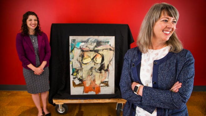 Olivia Miller, curator of exhibitions for the University of Arizona Museum of Art in Tucson, left, and Meg Hagyard, interim director, are all smiles after the return of "Woman-Ochre" to the museum. A similar painting by de Kooning in the same series sold for $137.5 million in 2006.
