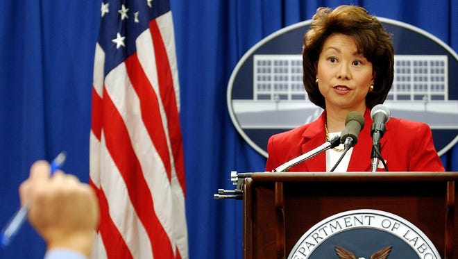Elaine Chao calls on a reporter during a news conference at the Department of Labor on Oct. 7, 2002, in Washington.