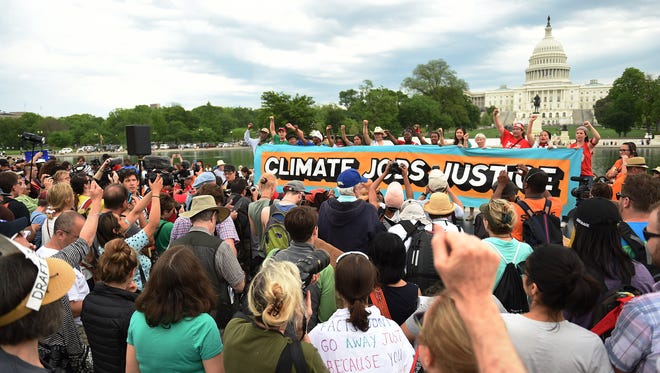 People gather near the U.S. Capitol for the People's Climate March on April 29, 2017 in Washington, D.C.