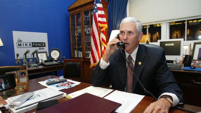IN-PENCE -- Rep. Mike Pence, R-Ind., talks on the phone on Wednesday, Nov. 15, 2006, in his office in the Cannon building in Washington. (Gannett News Service, Heather Wines)